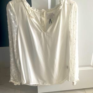 White blouse with accent sleeves.